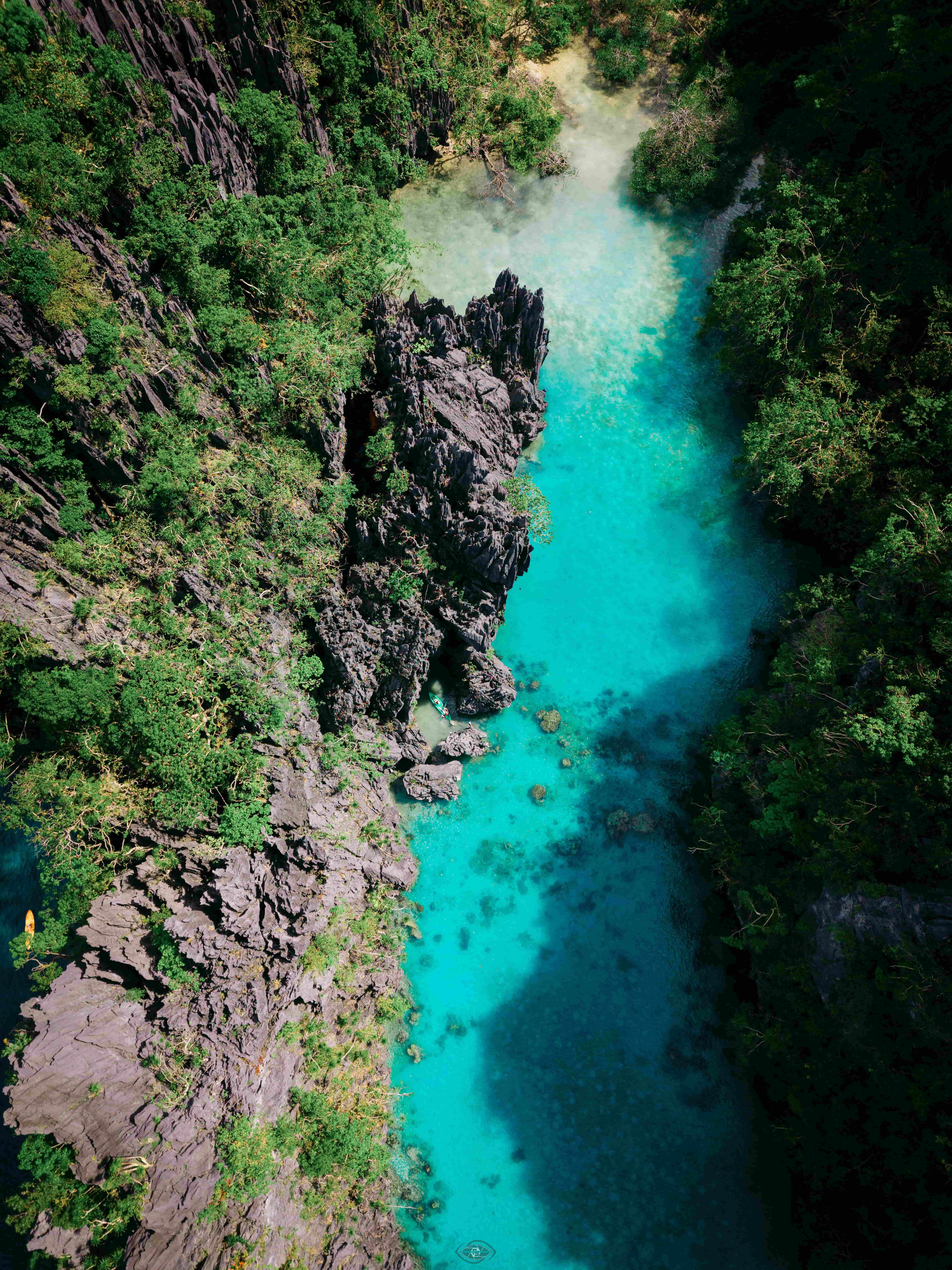 Kayaking into the Big Lagoon between towering limestone cliffs, El Nido, Palawan