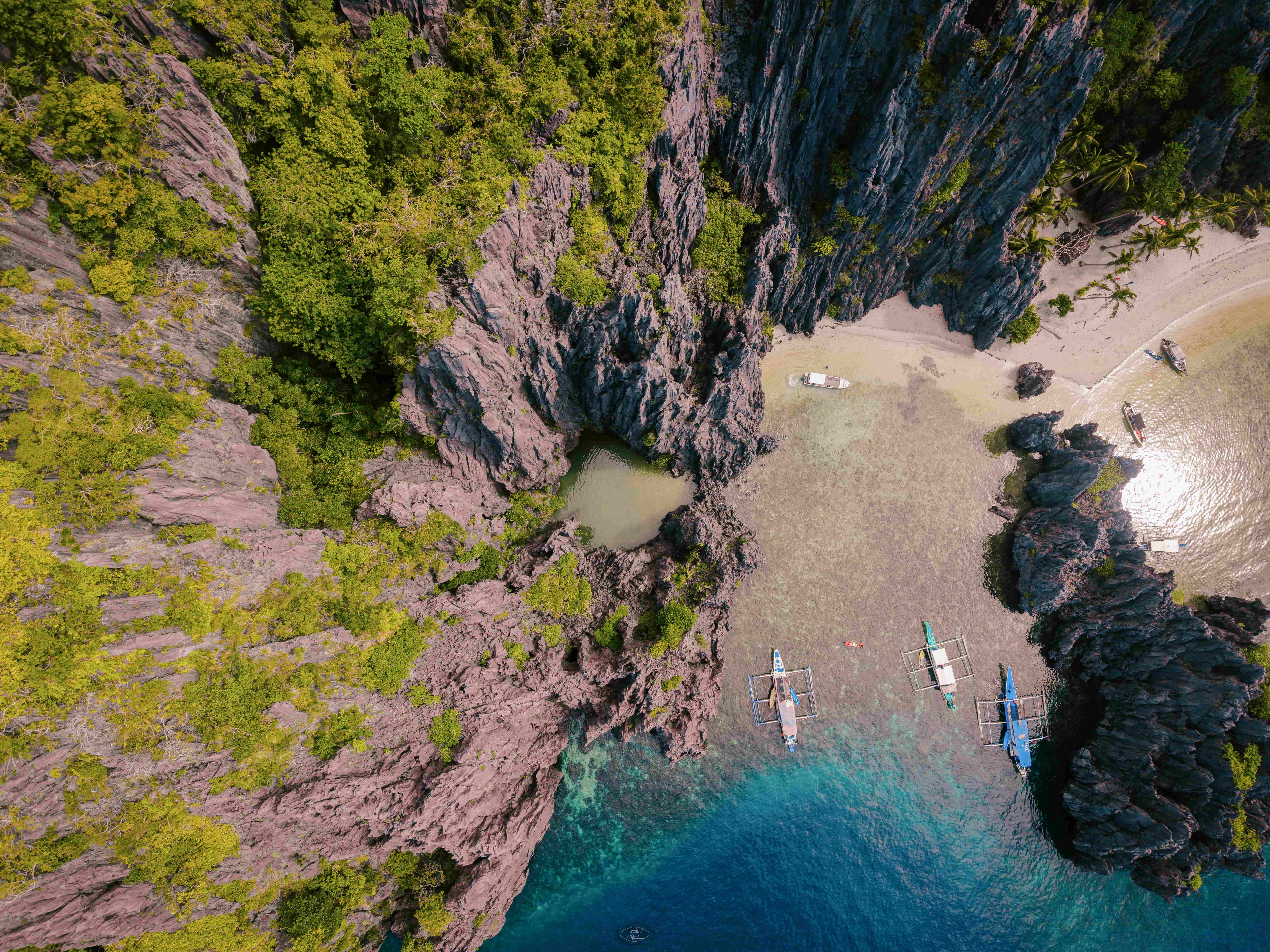 A private lagoon in El Nido with turquoise water and limestone cliffs